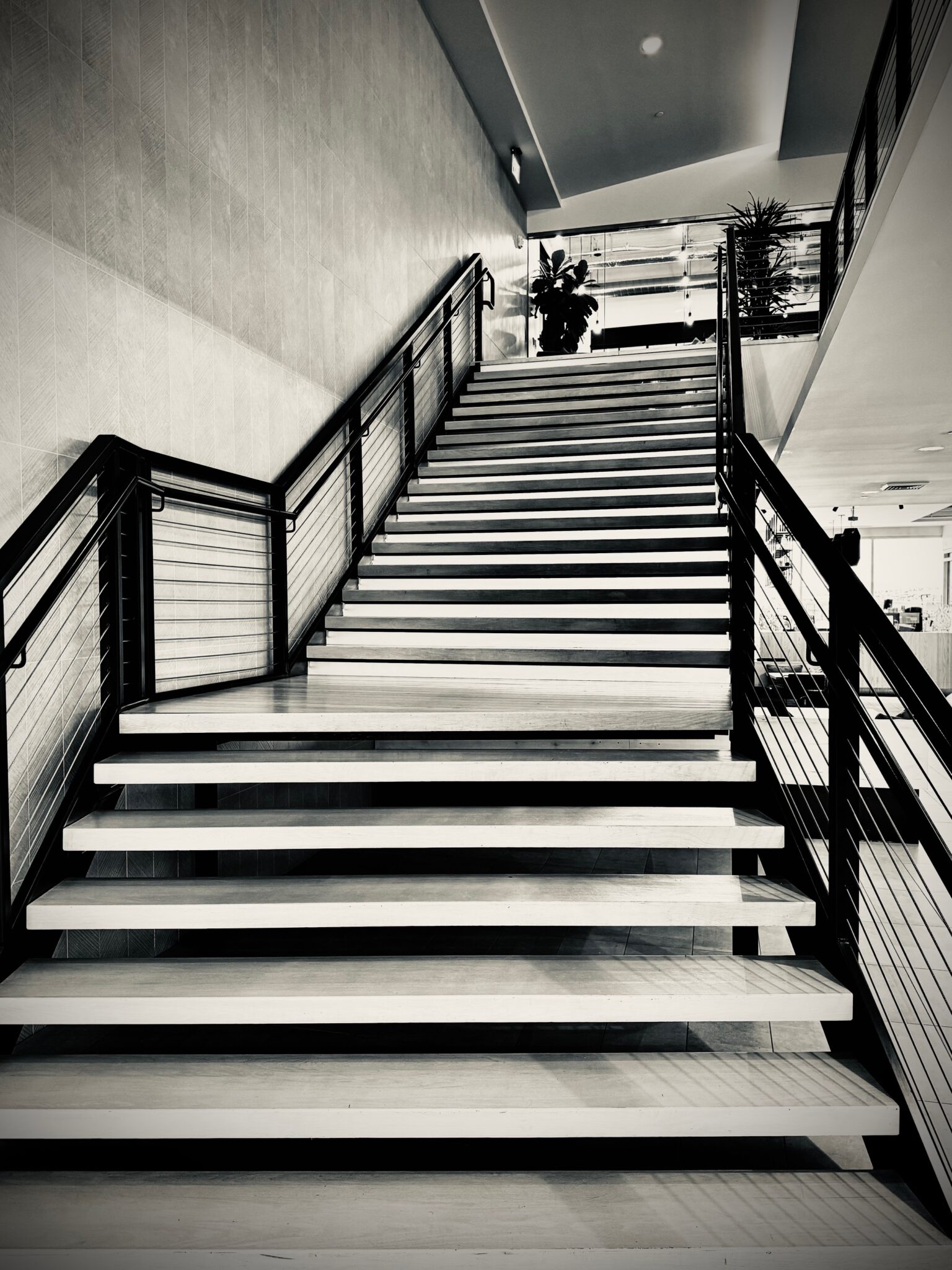 Black-and-white photograph of the staircase inside the JTB Law office building